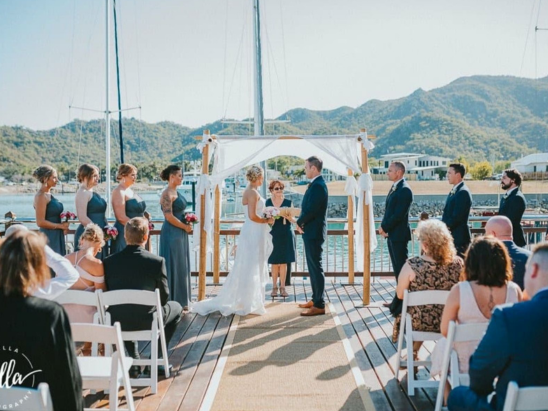 Sailboat waters edge wedding ceremony in Townsville with marriage celebrant Amanda Medill