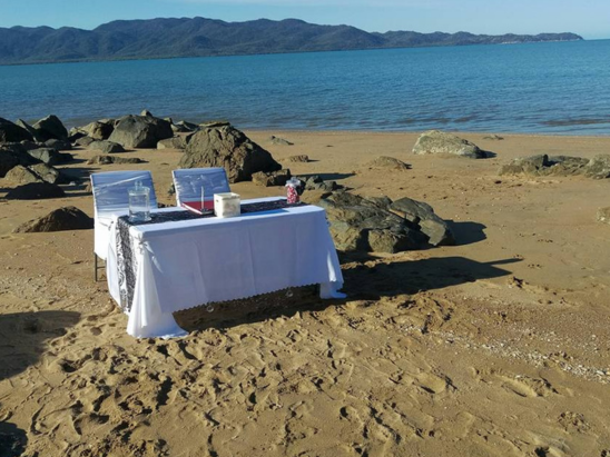 Beach wedding register signing in Townsville with marriage celebrant Amanda Medill