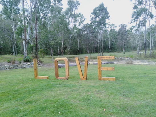 LOVE wedding letter furniture at bush marriage ceremony in Townsville with celebrant Amanda Medill
