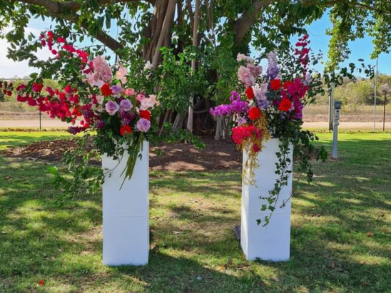 Wedding plinths with beautiful flower arrangements at marriage ceremony in Townsville with celebrant Amanda Medill